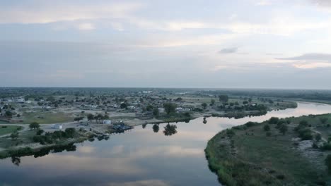 river flowing through dry town in african wilderness