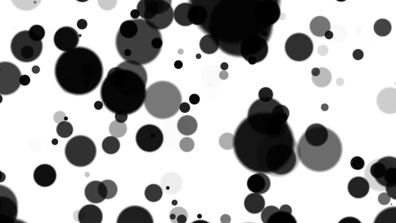 Large black and white particles move in space on a white background. Beautiful monochrome bokeh blurred background defocused lights