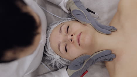 woman receiving a facial massage at a spa