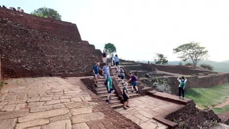 tourists exploring the ancient ruins of sigiriya, sri lanka