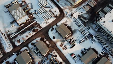 Lone-industrial-zone-with-trucks-parked-and-covered-with-snow-in-Calgary