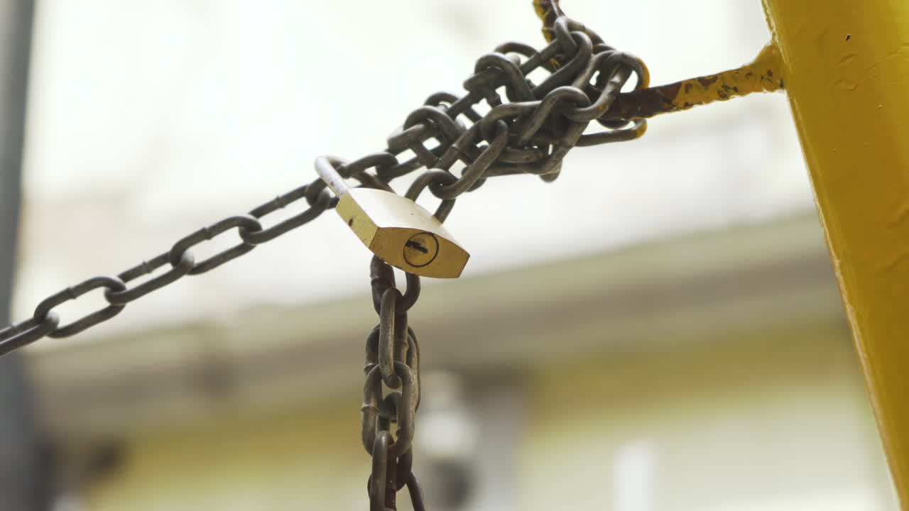A locked padlock and chain for security in Mexico City street