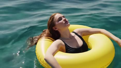 a serene moment on a sunny day, as a young woman enjoys the tranquil waters while relaxing in a bright yellow inflatable float, immersed in nature's beauty.