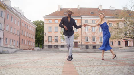 interracial couple dancing salsa in a public square 5