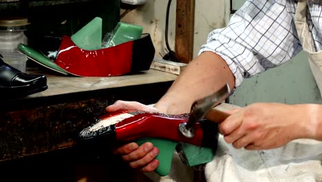 professional shoemaker making new shoes at his workshop