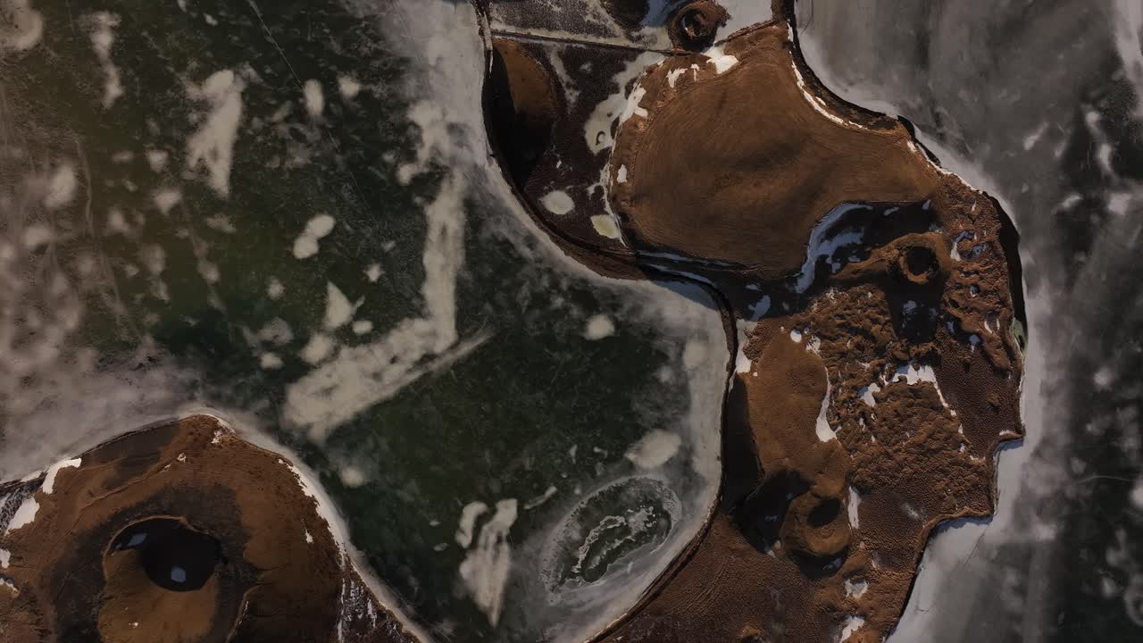 Frozen lake with volcanic craters in winter near Mývatn, Iceland, aerial view