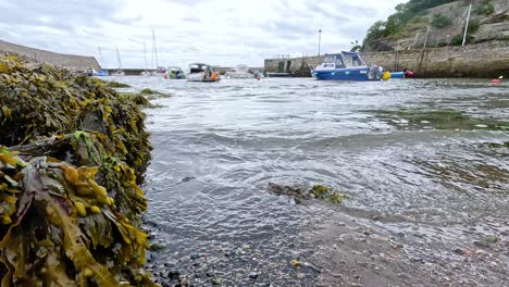 waves hitting pier with boats docked