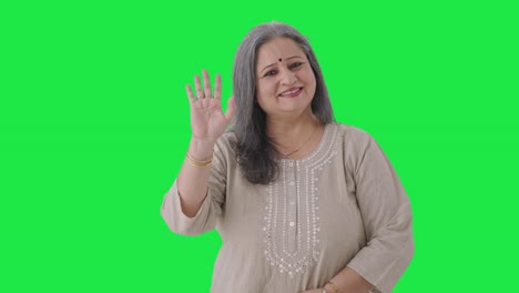 Happy-Indian-old-woman-waving-and-saying-hello-Green-screen