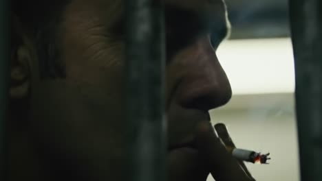 a captivating glimpse: the emotive expression behind bars in a dimly lit setting, encapsulating tension, reflection, and profound moments of inner conflict