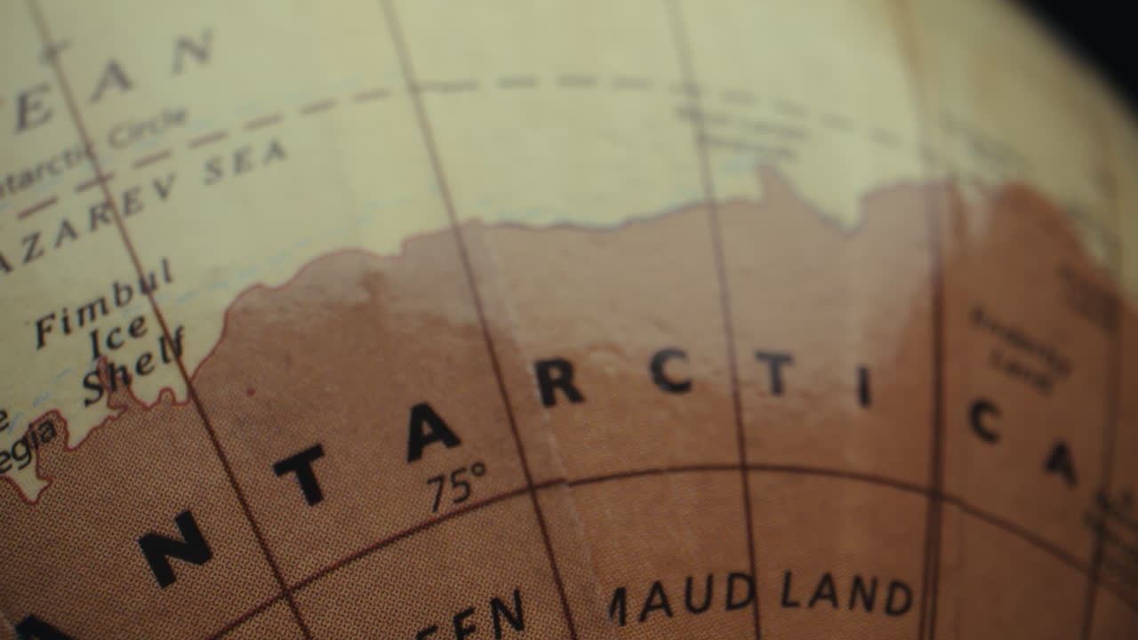 Close-up of a vintage world globe focused on Antarctica