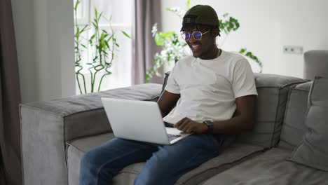 Black-man-works-at-a-laptop,-makes-video-conferences-or-video-call