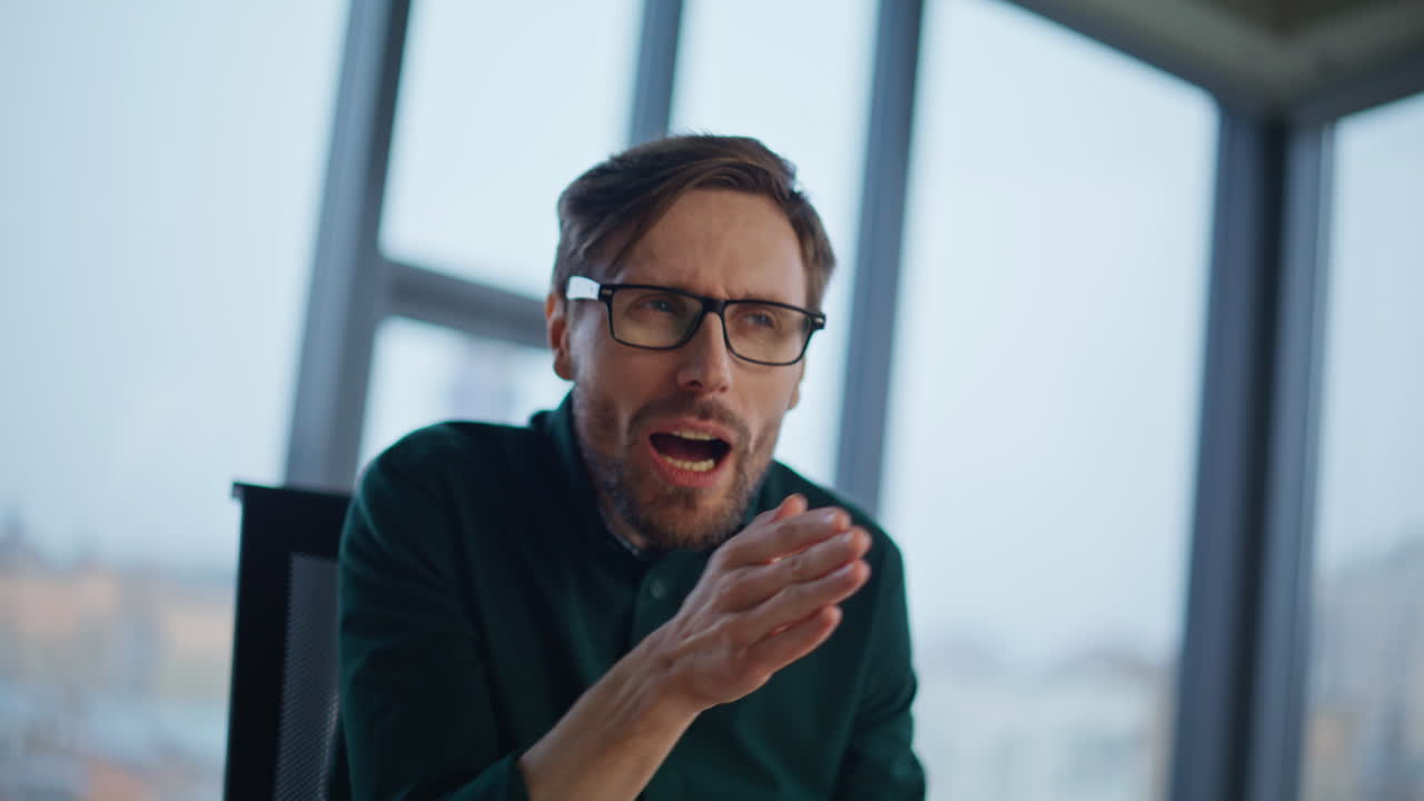 Videocalling entrepreneur explaining project to webcam laptop in office closeup