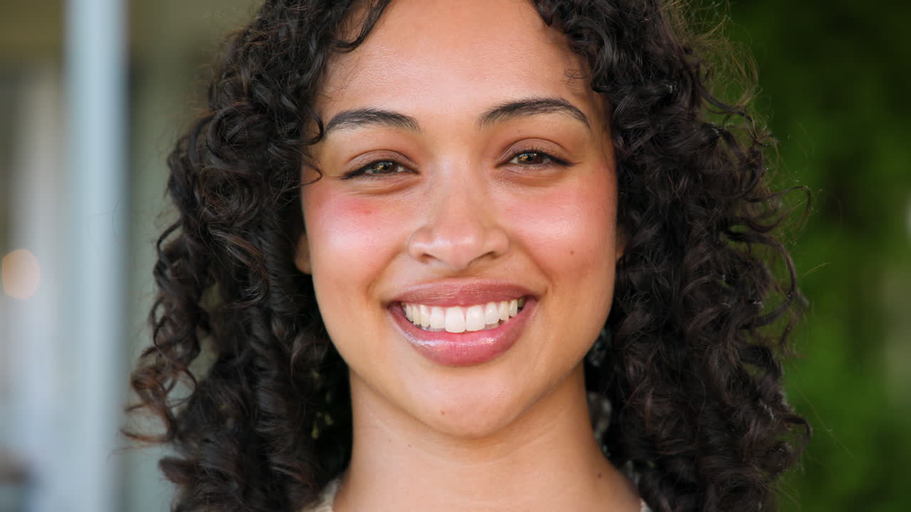 Smiling woman outdoors, enjoying bright and cheerful day in sunshine