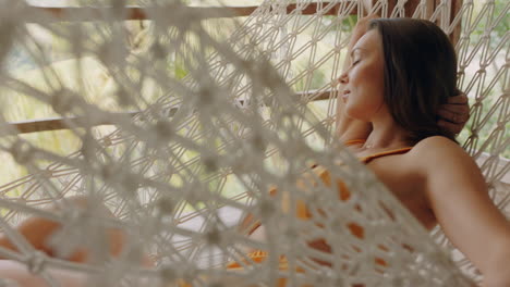 attractive-woman-in-hammock-enjoying-comfortable-lifestyle-on-vacation-in-holiday-resort-swaying-peacefully-on-lazy-summer-day-in-tropical-paradise-cabin