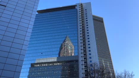 messeturm trade fair tower mirrored inside windows of kastor pollux building