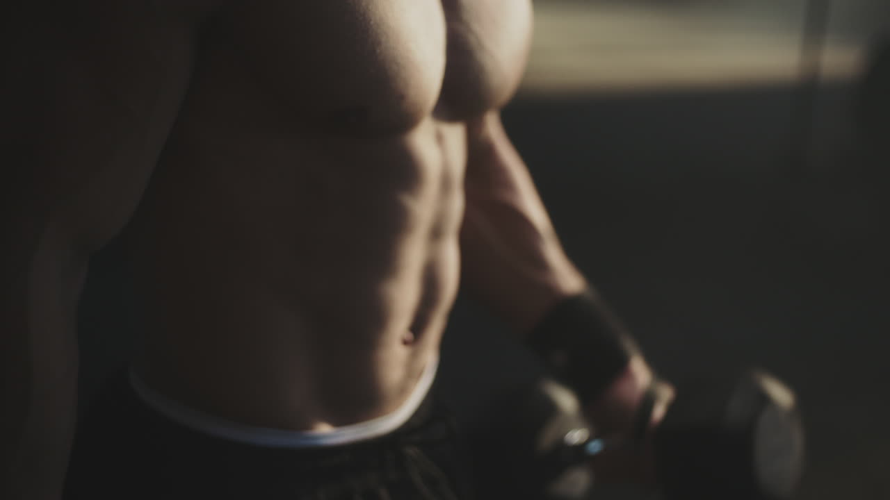 Muscular Man Working Out with Dumbbells