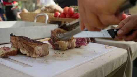 cutting barbecue meat at mexican event with tomatoes and bread