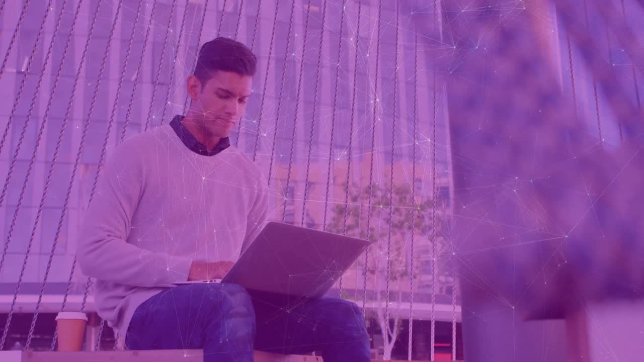 Animation of connections over caucasian man working on laptop