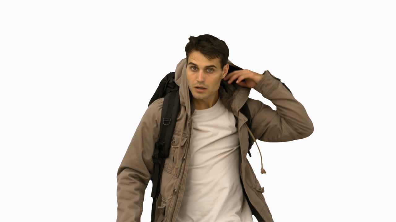 Handsome man walking towards the camera on white screen