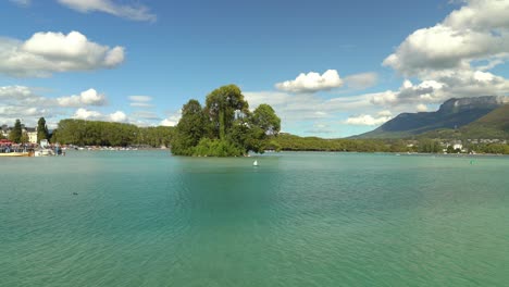 a glacial annecy lake, dubbed “the purest lake in europe, formed 15,000 years ago by melting ice from the alps