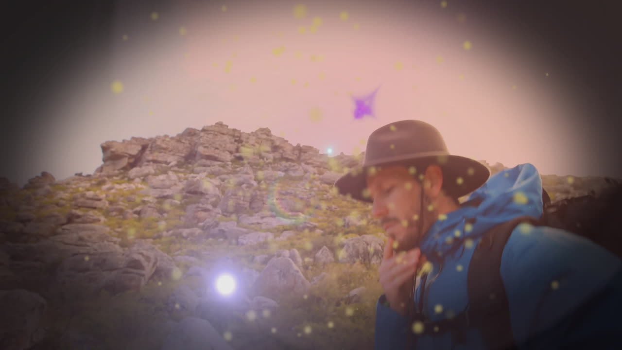man hiking on rocky hillside, health theme showing floating golden sparkles and gear statistics