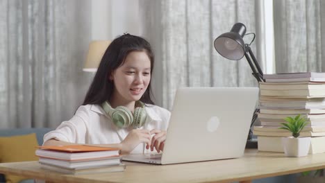 teenage girl studying online at home