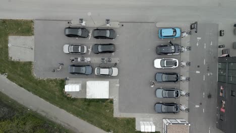 drone shot of a charging station filled with electric cars