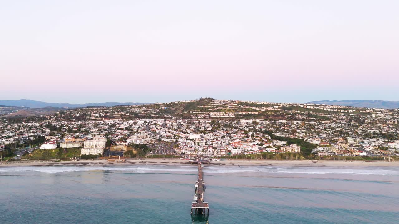 Aerial View of southern california pier with a beautful orange sunset