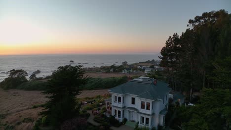 Aerial-view-of-an-old-money-mansion-overlooking-the-California-sunset