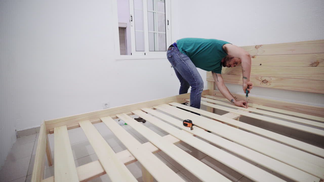 Fixing furniture bed screws manually hispanic guy