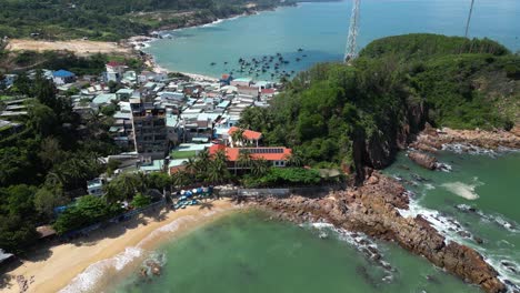 flying over bai xep beach with fishing village in distance in slow motion