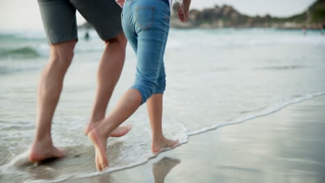 family running on the beach