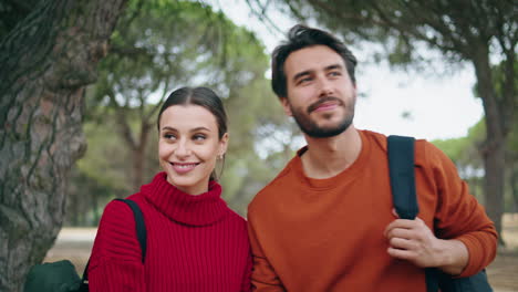 tourists love kissing walking at beautiful forest close up. couple enjoy stroll.