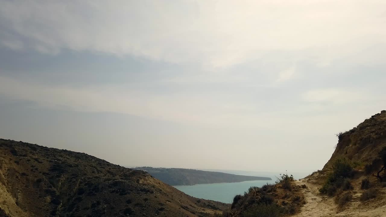 From the cliffs of Pissouri, a winding footpath leads down through a valley toward the distant blue sea. This scenic view captures Cyprus’s layered landscapes and peaceful coastal charm.