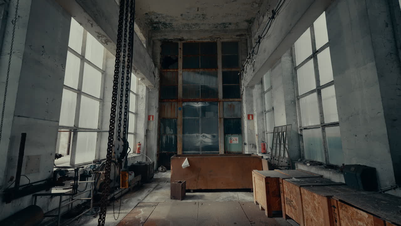 Interior View of an Abandoned Industrial Factory with Large Windows