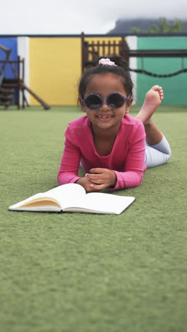 vertical video: in a school setting, a young asian girl is reading a book
