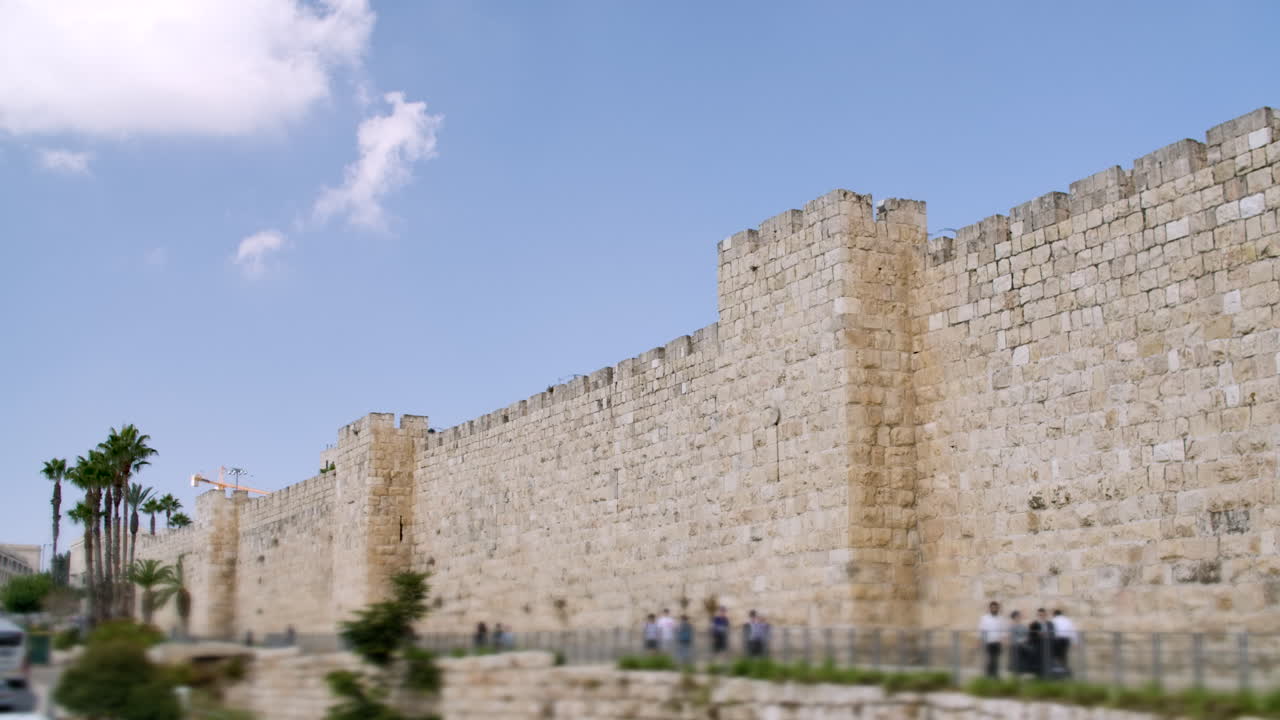 A blurred crowd walking in front of the ancient wall in Israel