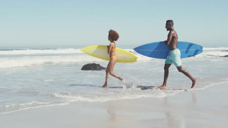 african american couple ready to go surf