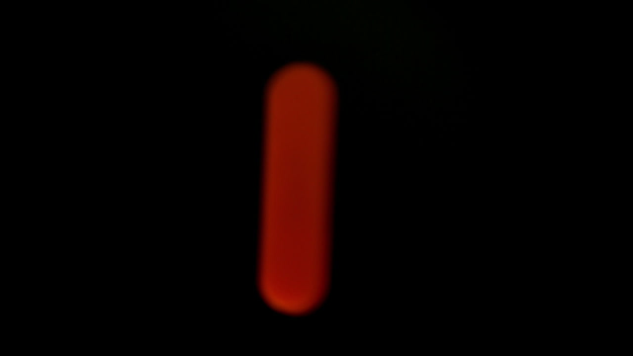 The letter l coming into focus on black background