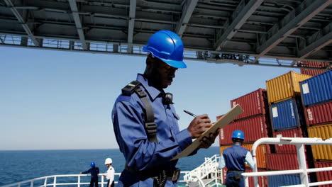 worker inspecting cargo on a container ship