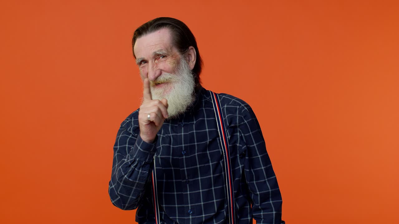 Senior old man shakes finger and saying no, be careful, avoid danger mistake, disapproval sign