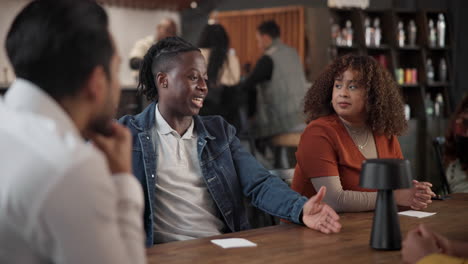 diverse group having a conversation in a cafe.