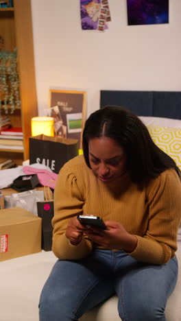 woman using a smartphone in a bedroom