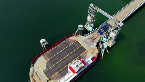 aerial view of a car being loaded onto a private ferry serving the herron island community