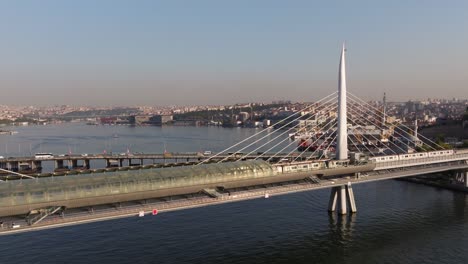 istanbul subway train crosses golden horn metro bridge at sunrise in capital city