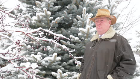 cinemograph of a man standing in a snow storm motionless as the winter whorls around him - endlessly looping