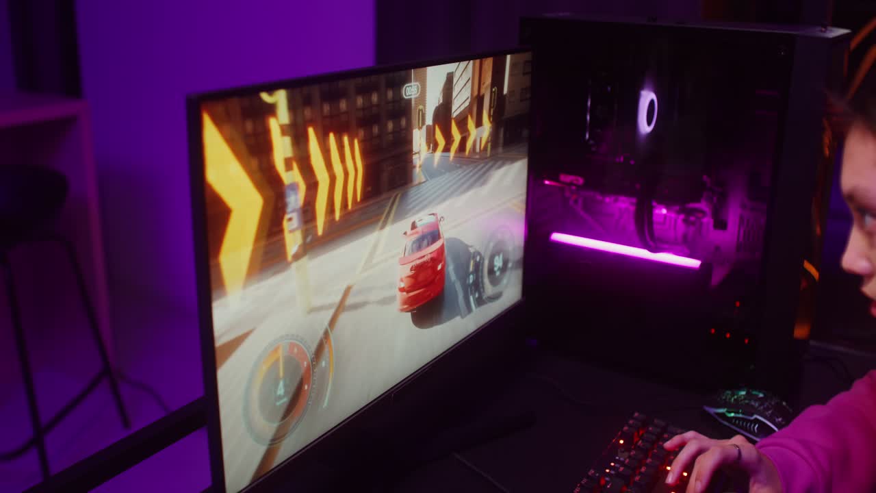 A gamer playing a racing video game on their PC