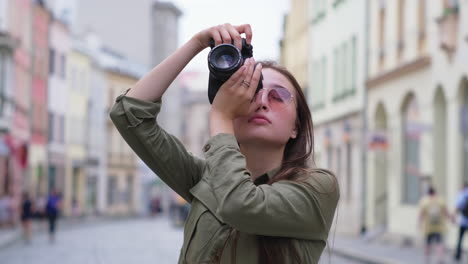 woman taking picture on street