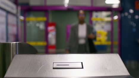 person using a transit turnstile