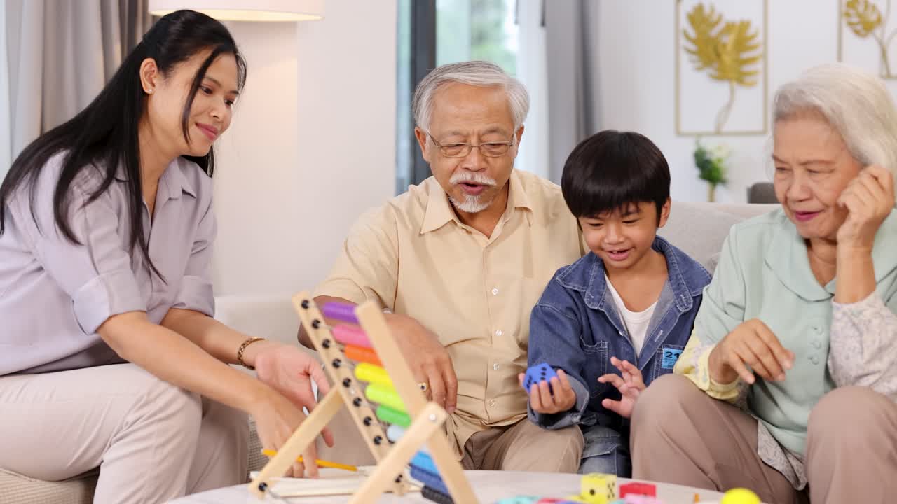 Multigenerational Asian family playing colorful dice game together, bonding joyfully in cozy living room